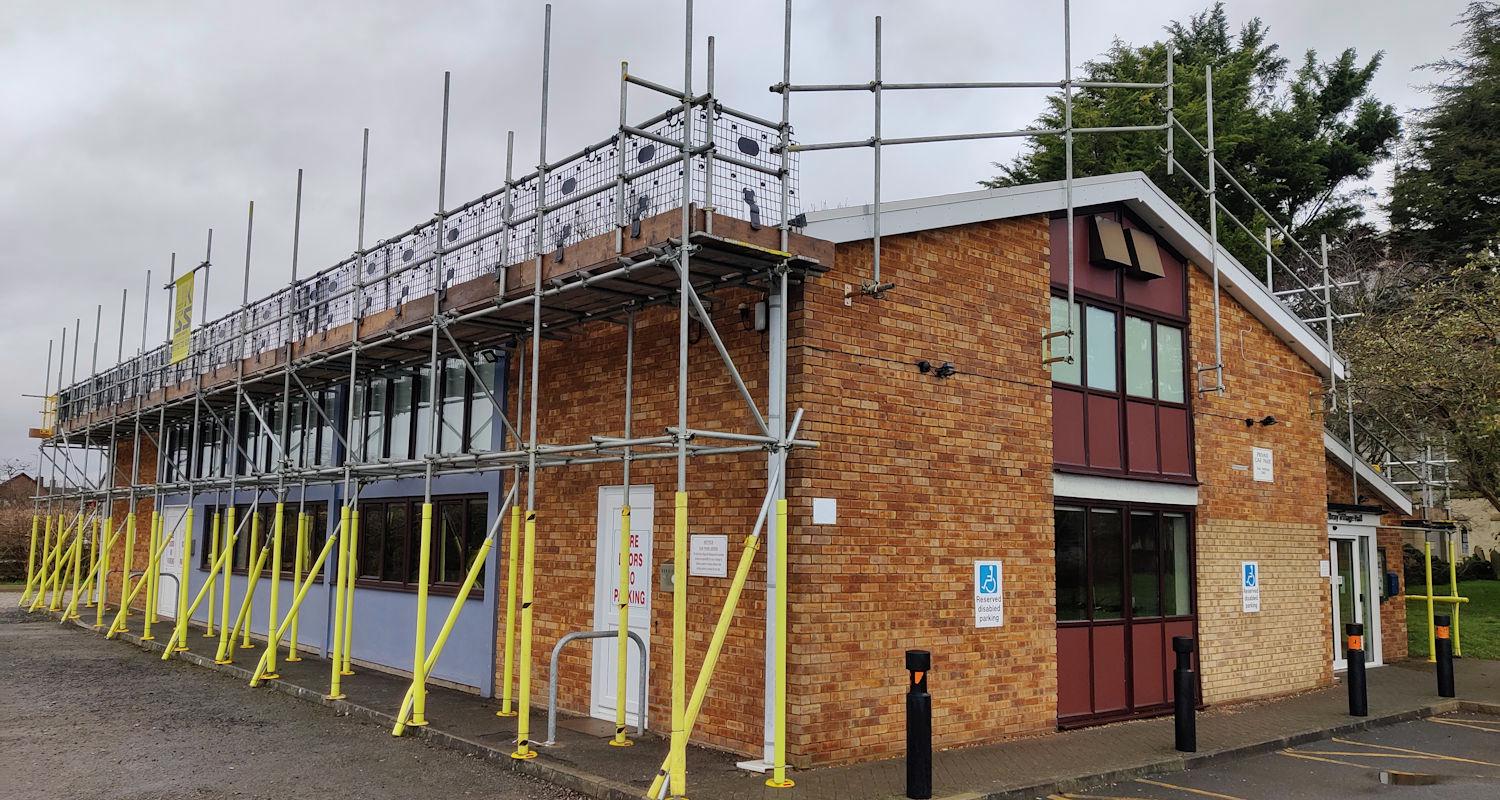 Eaton Bray Village Hall viewed from car park with scaffolding up around the building